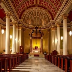 Empty Cathedral Seats and Hallway With Lights Turned on